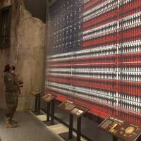 FORT BELVOIR, Virginia- U.S. Army Historian Maj. Sandy Knoll gazes up at a statistical display at the National Museum of the U.S. Army, a U.S. flag of toy Soldiers representing the over 11 million U.S. Soldiers who served during World War II. Today, many years ahead of the Women's Services Integration Act of 1948 and even five years past the full integration of women into all military occupations since Dec. 4, 2015, women comprise 18 percent (about 200,000) of the total strength of the Army, according to the 2020 Office of Army Demographics. (Photo by Master Sgt. Crista Mary Mack, U.S. Army Center of Military History)